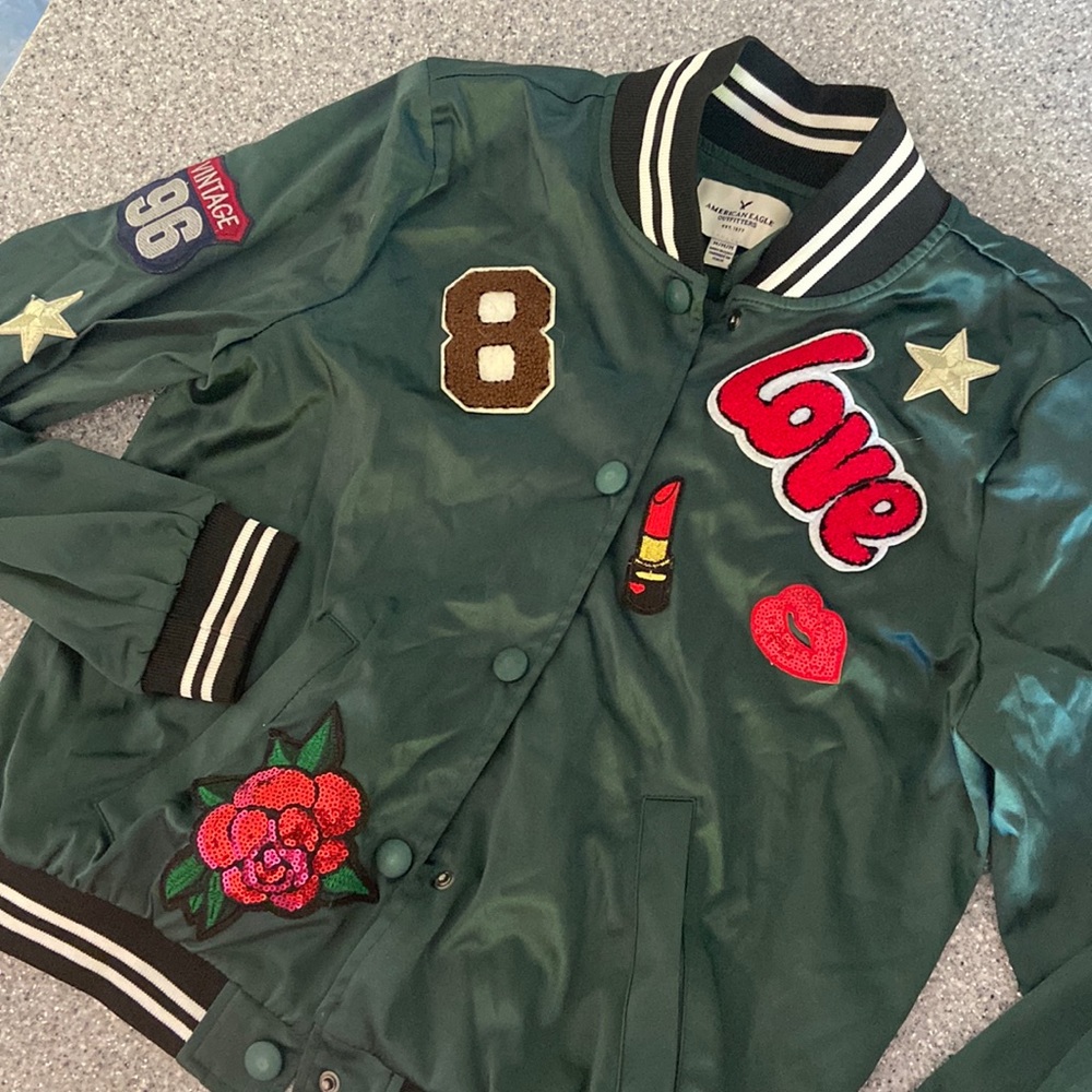 AE green “bomber” jacket with decals. Size M Teen